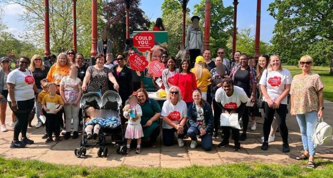 The Foster Walk team at the Royal Borough of Greenwich local authority stand together in the park on a sunny day 