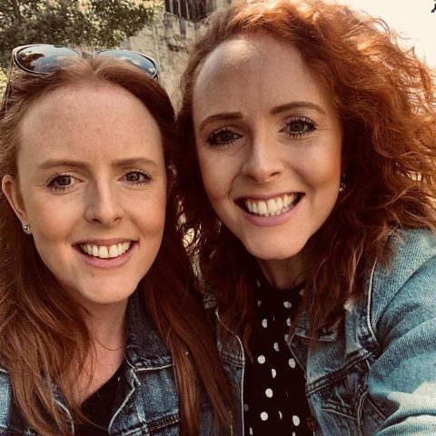 Selfie of identical twin sisters Olivia and Candice smiling into the camera 